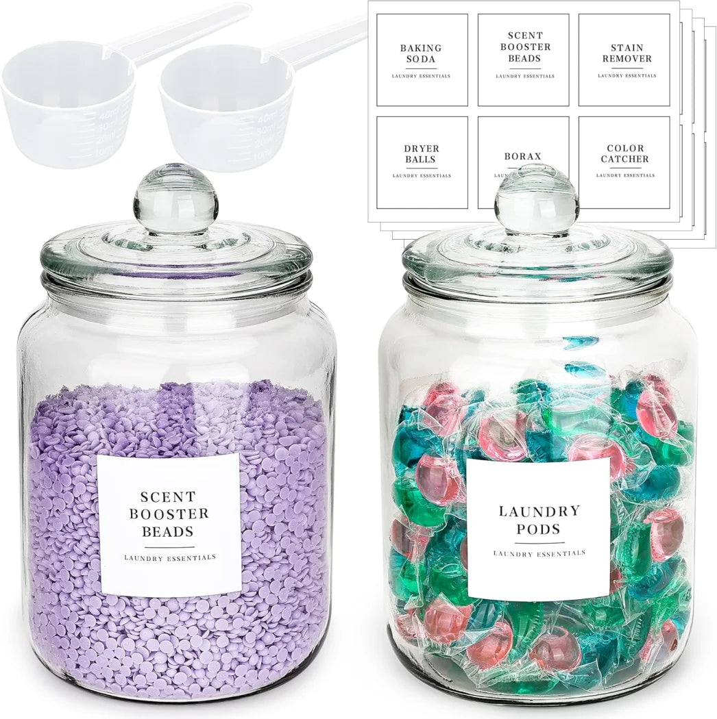 Look at these half‑gallon glass jars — airtight lids, labels, and matching spoons for detergent, pods, and scent boosters. Clean storage, modern laundry décor, and beautifully organized shelves.
