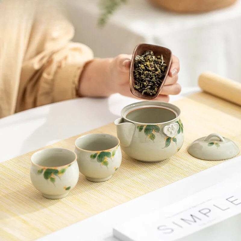 Hand-painted and Osmanthus Kung Fu Tea Set — one pot, two cups, and a travel storage bag.