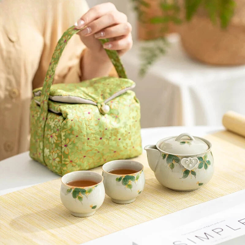 Hand-painted and Osmanthus Kung Fu Tea Set — one pot, two cups, and a travel storage bag.
